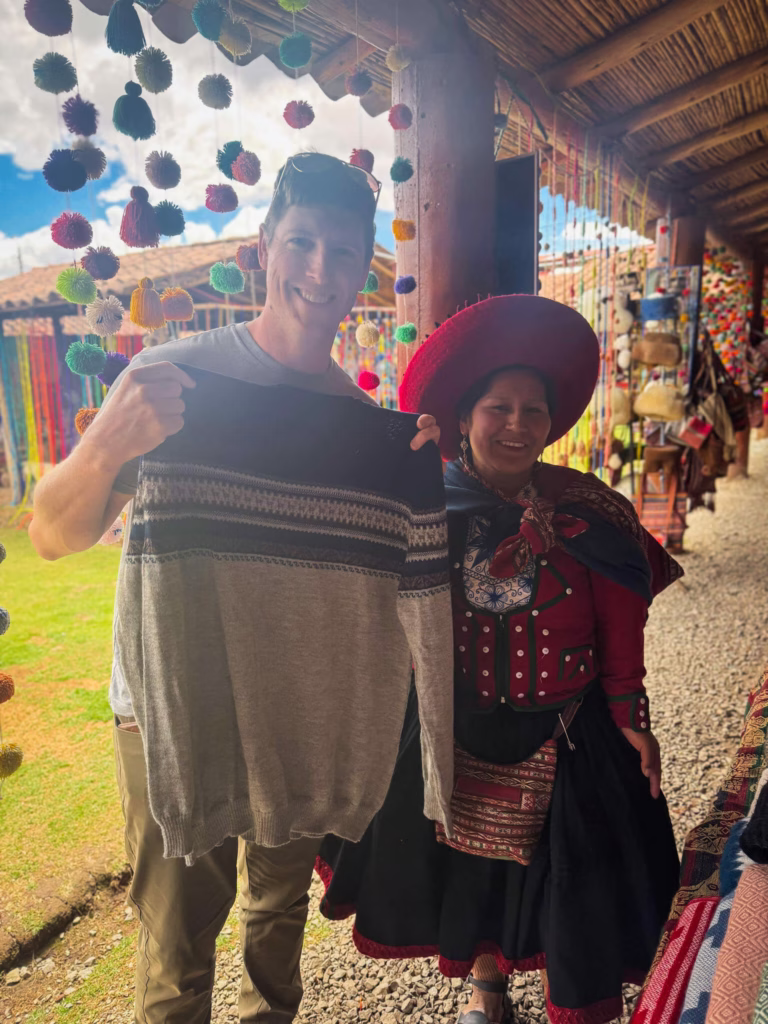 Scott with his sweater and the woman who made it